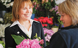 Two women choosing flowers in a florist