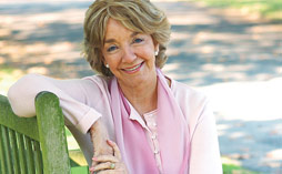 A woman smiling in a garden of remembrance