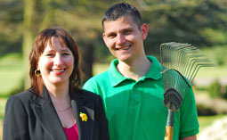 A funeral director and a gardener in a garden of remembrance