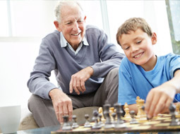 An older man and young boy playing chess
