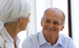 A man looking at a woman and smiling